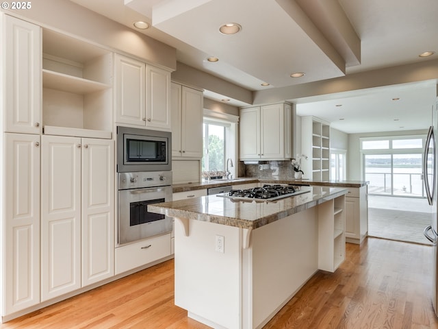 6903 SE Riverside Dr Unit 20, Vancouver, WA 98664 - kitchen with appliances with stainless steel finishes, healthy amount of natural light, a center island, white cabinets, and recessed lighting