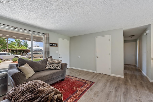 1220 Baker St, Baker City, OR 97814 - living area featuring wood finished floors, a textured ceiling, and baseboards