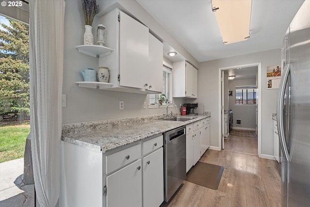 1220 Baker St, Baker City, OR 97814 - kitchen with stainless steel appliances, a sink, light wood-type flooring, and white cabinetry