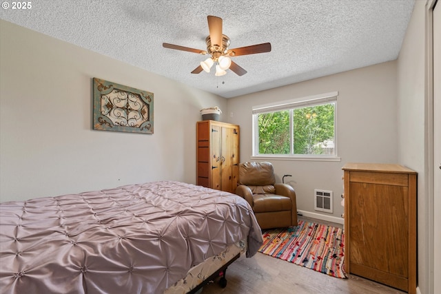 1220 Baker St, Baker City, OR 97814 - bedroom featuring a textured ceiling, wood finished floors, and ceiling fan