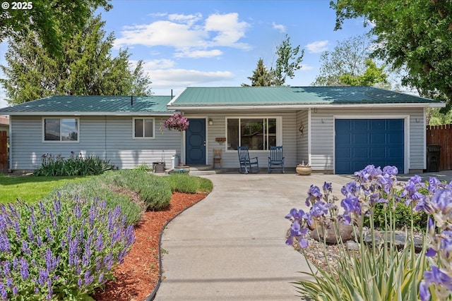 1220 Baker St, Baker City, OR 97814 - ranch-style house with a garage, driveway, covered porch, and metal roof