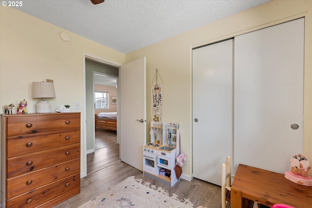 1220 Baker St, Baker City, OR 97814 - bedroom featuring wood finished floors, a closet, and a textured ceiling
