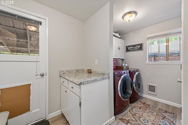 1220 Baker St, Baker City, OR 97814 - washroom with cabinet space, washer and dryer, light wood-style flooring, baseboards, and heating unit
