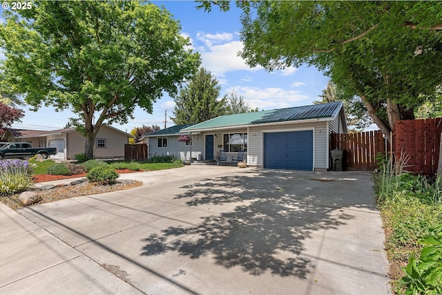 1220 Baker St, Baker City, OR 97814 - ranch-style home featuring a garage, concrete driveway, and metal roof