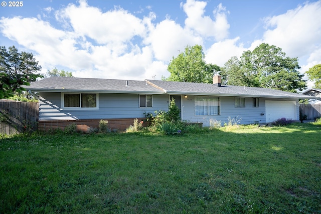 rear view of property with a chimney and a garage