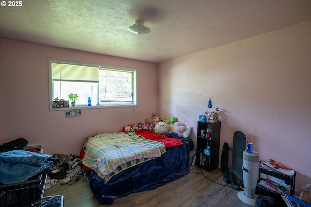 bedroom with wood finished floors