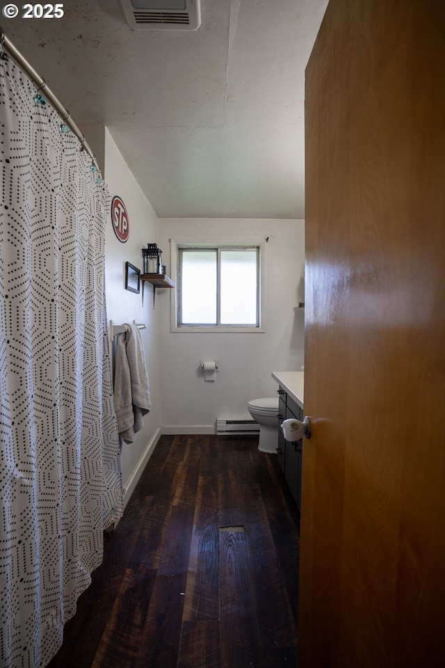 bathroom with wood finished floors, a baseboard radiator, toilet, vanity, and baseboards