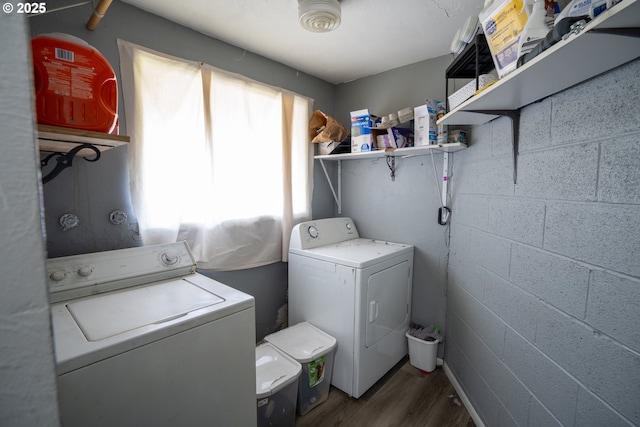 laundry area with separate washer and dryer and dark wood-style flooring