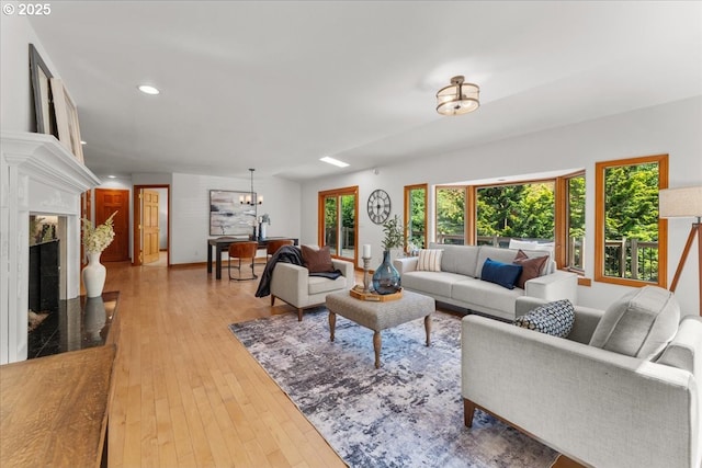 9150 SW Salmon St, Portland, OR 97225 - living room featuring a fireplace, a chandelier, hardwood / wood-style flooring, and recessed lighting