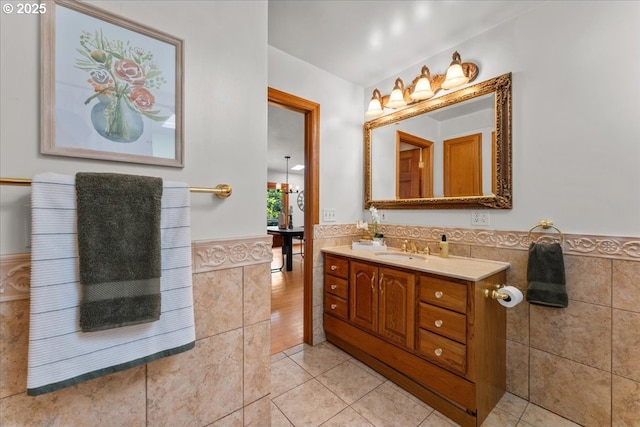 9150 SW Salmon St, Portland, OR 97225 - bathroom with tile walls, wainscoting, vanity, tile patterned floors, and a chandelier