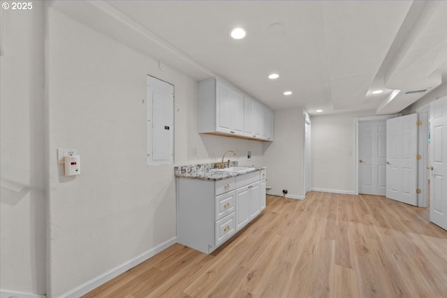 9150 SW Salmon St, Portland, OR 97225 - laundry room with electric panel, light wood-type flooring, and recessed lighting