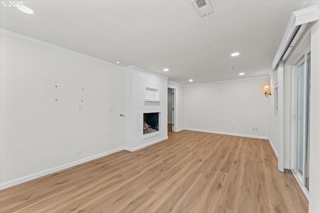 9150 SW Salmon St, Portland, OR 97225 - unfurnished living room with ornamental molding, light wood-type flooring, recessed lighting, and a fireplace