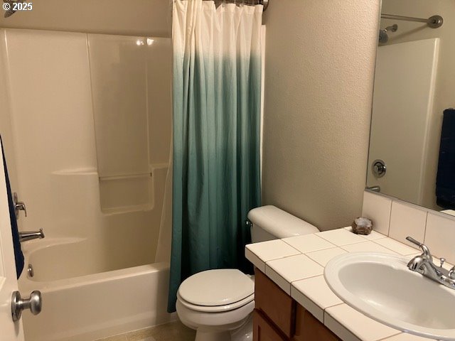 full bath featuring toilet, shower / bath combo, and vanity