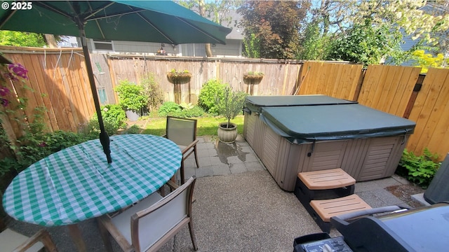 view of patio with a hot tub and a fenced backyard