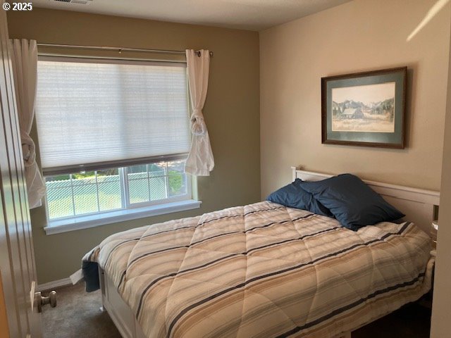 carpeted bedroom with baseboards