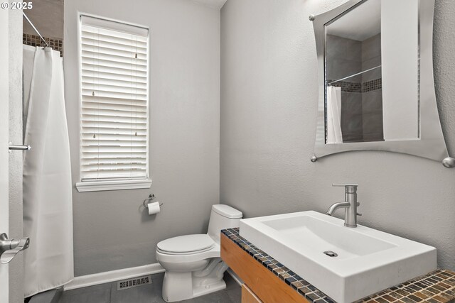 bathroom featuring vanity, an enclosed shower, and tile patterned flooring