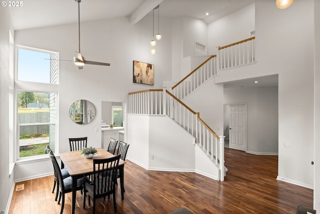 dining area with ceiling fan, dark hardwood / wood-style floors, high vaulted ceiling, and beam ceiling