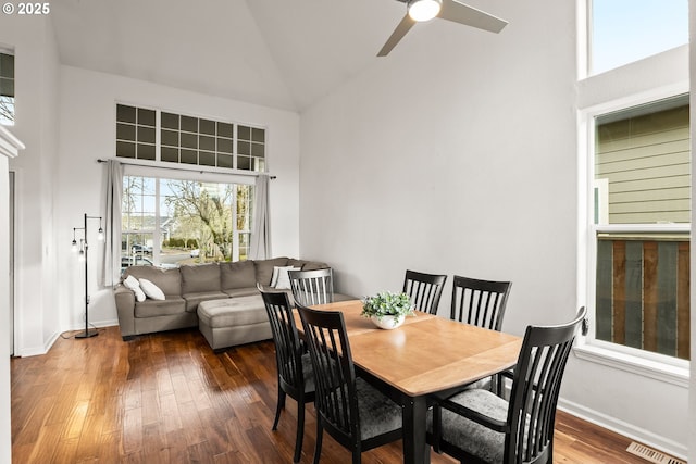 dining space featuring ceiling fan, dark hardwood / wood-style floors, and high vaulted ceiling