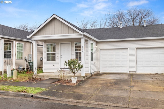 view of front facade with board and batten siding, an attached garage, concrete driveway, and roof with shingles