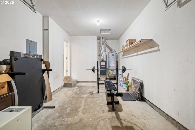 exercise area featuring water heater and baseboards