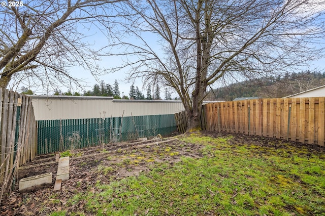 view of yard with a fenced backyard