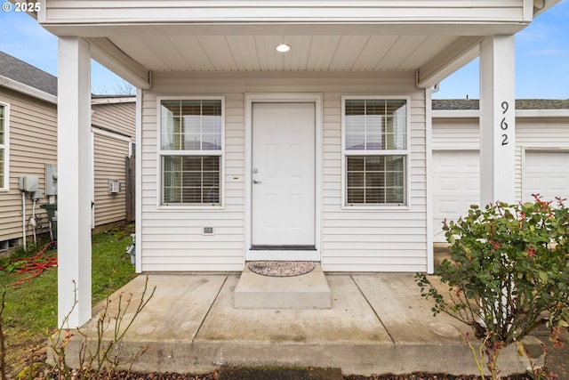 property entrance featuring an attached garage