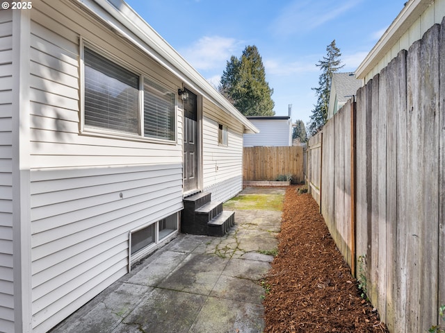 view of side of home with a patio