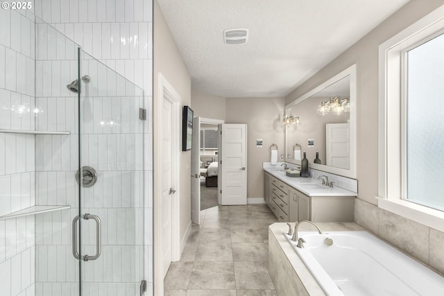 17641 NW Layla Dr, Portland, OR 97229 - ensuite bathroom featuring double vanity, a shower stall, a garden tub, a textured ceiling, and baseboards