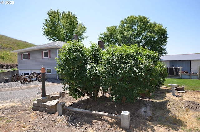 46083 Adams Rd, Pendleton, OR 97801 - view of property exterior with a garage and a chimney
