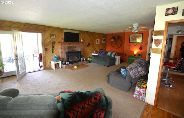 46083 Adams Rd, Pendleton, OR 97801 - living area with a ceiling fan, wooden walls, a brick fireplace, and french doors