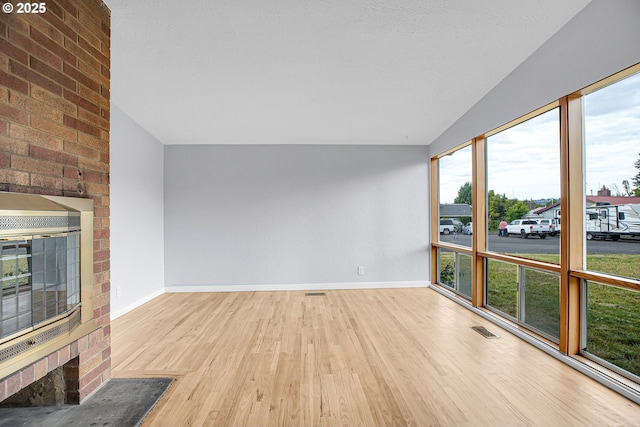 6255 SW Mad Hatter Ln, Beaverton, OR 97008 - unfurnished living room with wood finished floors and vaulted ceiling