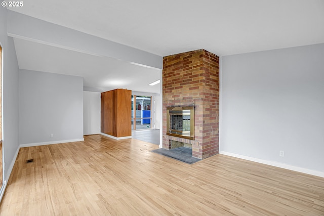 6255 SW Mad Hatter Ln, Beaverton, OR 97008 - unfurnished living room featuring a brick fireplace and light wood finished floors