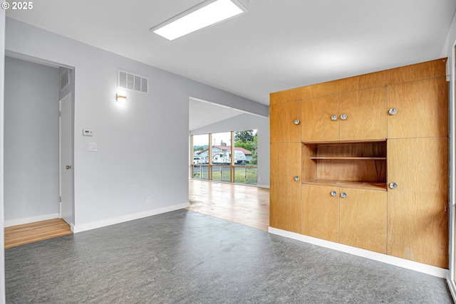 6255 SW Mad Hatter Ln, Beaverton, OR 97008 - unfurnished living room featuring baseboards and lofted ceiling