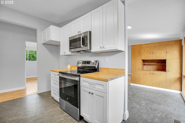 6255 SW Mad Hatter Ln, Beaverton, OR 97008 - kitchen with appliances with stainless steel finishes, wooden counters, and white cabinets