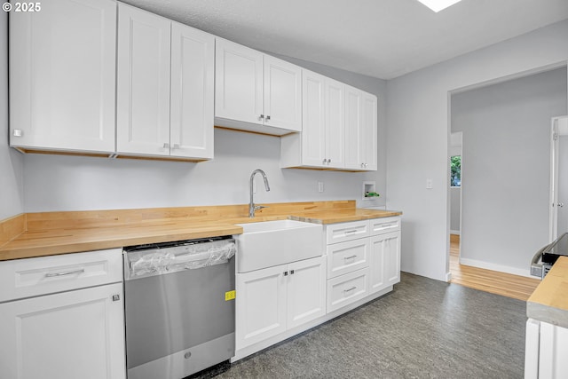 6255 SW Mad Hatter Ln, Beaverton, OR 97008 - kitchen with butcher block counters, stainless steel dishwasher, tile patterned floors, and white cabinets