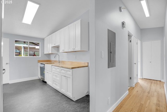 6255 SW Mad Hatter Ln, Beaverton, OR 97008 - kitchen with stainless steel dishwasher, electric panel, butcher block counters, and white cabinetry