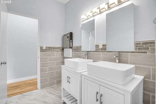 6255 SW Mad Hatter Ln, Beaverton, OR 97008 - full bath with double vanity, tile walls, a wainscoted wall, and marble look tiles