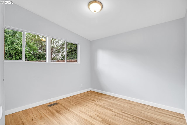 6255 SW Mad Hatter Ln, Beaverton, OR 97008 - spare room with vaulted ceiling, healthy amount of natural light, and light wood finished floors