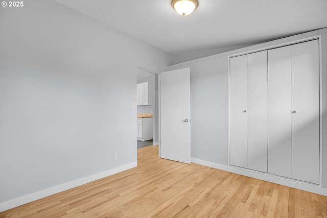 6255 SW Mad Hatter Ln, Beaverton, OR 97008 - unfurnished bedroom featuring light wood finished floors and a closet