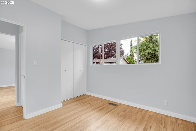 6255 SW Mad Hatter Ln, Beaverton, OR 97008 - unfurnished bedroom with wood finished floors and a closet