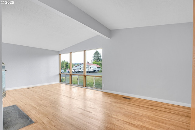 6255 SW Mad Hatter Ln, Beaverton, OR 97008 - unfurnished living room featuring wood finished floors and a textured ceiling