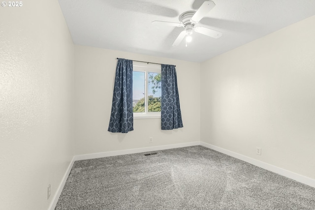 carpeted spare room featuring a ceiling fan, baseboards, and visible vents