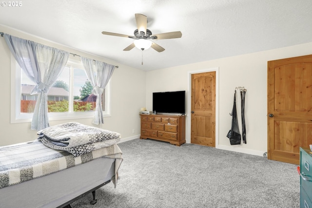 bedroom with baseboards, a ceiling fan, and carpet flooring