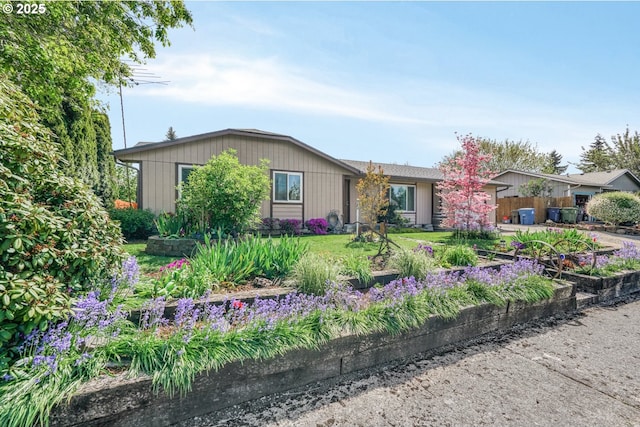 ranch-style house featuring fence