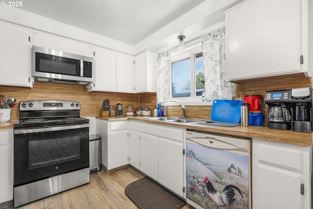 kitchen featuring a sink, white cabinetry, appliances with stainless steel finishes, and light countertops