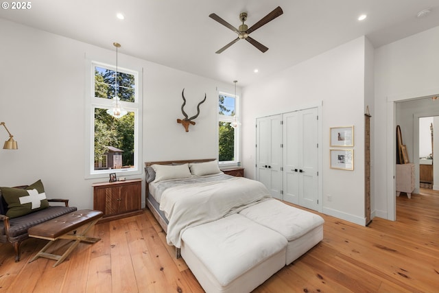 bedroom featuring a closet, ceiling fan, and light hardwood / wood-style flooring