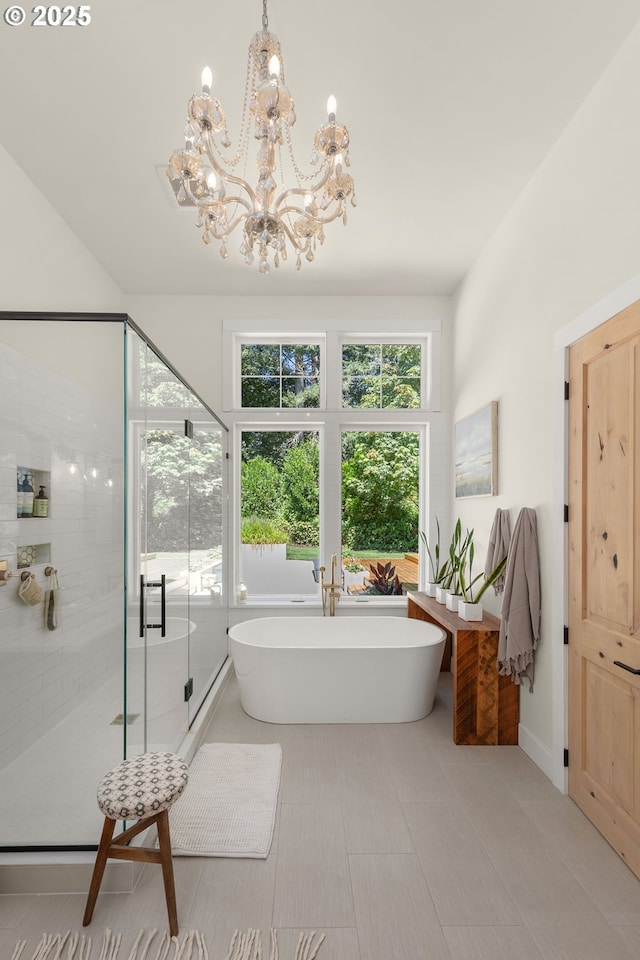 bathroom featuring a notable chandelier and independent shower and bath