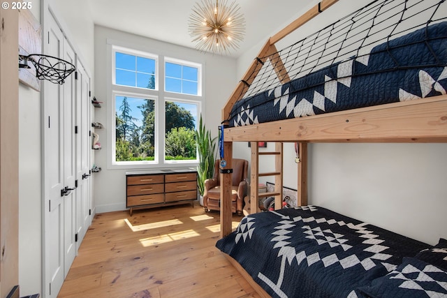 bedroom with a notable chandelier and light hardwood / wood-style flooring