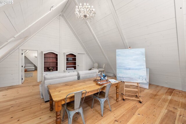 interior space with an inviting chandelier, vaulted ceiling with beams, light hardwood / wood-style flooring, and wood walls