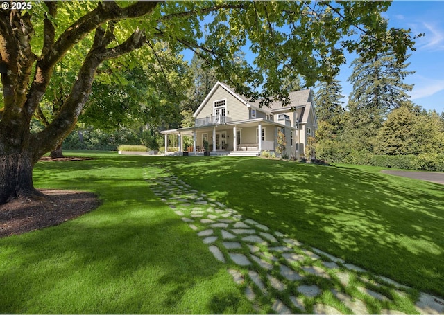 farmhouse-style home featuring a porch and a front yard